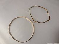 Two bracelets laid side by side showing overall shape and size