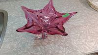 Star-shaped pink glass centerpiece bowl shown from above, revealing the five pointed edges and translucent quality of the glass.
