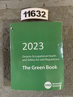 Front cover of the 2023 Green Book, titled Ontario Occupational Health and Safety Act and Regulations, showing clean green cover with white text and OSG branding.