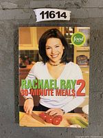 Front cover of the Rachael Ray 30 Minute Meals 2 cookbook showing Rachael Ray preparing tomatoes on a kitchen counter.