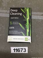 Front view of black box labeled Deep Cleaning Foot Patch with bamboo imagery, natural foot detoxification claims, and 20 pcs indicated