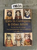 Front cover of the collage book showing illustrated cats dressed in cardigans and other attire.