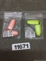 Two dual finger pet toothbrushes individually packaged in clear resealable plastic bags. One toothbrush is pink, the other lime green. Both have fine soft bristles designed for dental care of small pets.