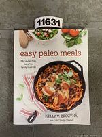 Front cover of 'Easy Paleo Meals' cookbook showing a skillet dish and fresh ingredients