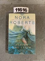 Front cover of the book Heaven and Earth by Nora Roberts, showing the title, author name, and illustration of a woman with flowing fabric.
