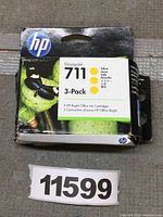 Front view of HP 711 3-pack yellow ink cartridge box with butterfly image and product information