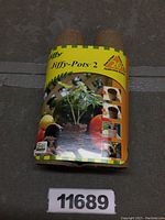 Front view of the two Jiffy-Pots 2 bundled with yellow branded packaging showing product name and usage visuals.