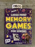 Front cover of the large print memory games book, showing the title and colorful design related to brain games.