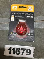 Front view of the Nathan HyperBrite Orb strobe light in original packaging showing the product and branding.