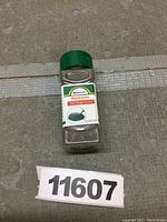 Clear plastic jar with green lid labeled SPACECARE Magnetic Iron Powder Filings 12 oz