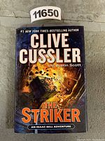 Front cover of 'The Striker' book by Clive Cussler and Justin Scott showing title and imagery.