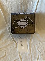 Front view of Batman vs Superman Special Edition metal collector case showing Batman and Superman logos.