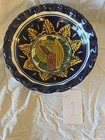 Top view of the handmade Mexican ceramic bowl showing the hand-painted fruit design inside the bowl and scalloped rim.