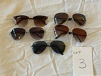 Photo showing all five pairs of sunglasses laid flat, highlighting different lens tints and frame designs.