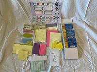 Full view of all sticky notes and label sheets arranged on a light fabric background