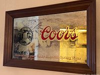 Front facing view of Coors beer bar mirror showing design and condition.