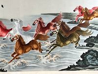 Close-up of embroidered horses in red, white, brown, and green colors galloping through painted water with wave details.