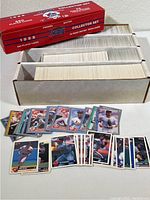 Full view of the 1988 Score Collector Set box opened to show multiple rows of unsleeved baseball cards, plus a small display of front-facing and back-facing cards spread in front of the box.
