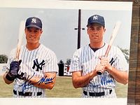 Color photo of Kevin and Jason Mass in Yankees uniforms holding baseball bats with signatures.