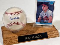 Autographed baseball in protective case on wood stand with Ryan Klesco card