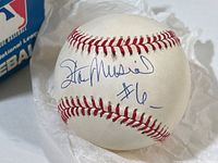 Close-up showing Stan Musial signature and number 6 inscription on the baseball.