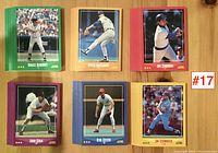 Six different 1987 Score baseball cards with colorful borders spread out on a table to show examples from the lot. Cards include Bruce Benedict, Doyle Alexander, Jim Sundberg, John Kruk, Ron Oester, and Jim Essiencki.