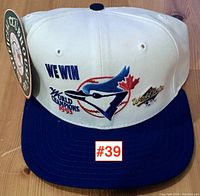 Front view of baseball cap showing embroidered logo, text and colors.