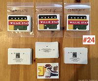 Three plastic bags labeled 'complete' each containing a complete Willie Stargell baseball card puzzle with puzzle pieces spread below each bag.