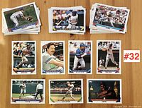 Group of 40 baseball cards from 1992 Topps with various players including Barry Bonds and Chuck Knoblauch visible laid out on a wooden surface.