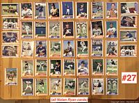 Photo showing 48 Nolan Ryan baseball cards laid out in a grid on a table, various card designs and poses included.