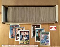 Photo showing a large box filled with ungraded 1987 Topps baseball cards with a few cards selected at random for display.