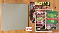 Photo shows 1982 baseball sticker album labeled Giants alongside Topps Ironman 1992 sports magazine and Official Baseball Card Price Guide 1992 edition.