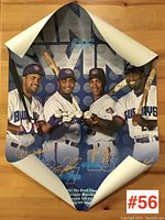 Curled vintage 'Kings of Swing' Blue Jays poster partially rolled showing four players smiling with bats and baseballs.
