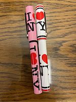 Two novelty pens with 'I ♥ NY' text; pink and white designs, front side view