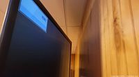 Side angle of the large black LG TV screen showing the HDMI 1 source label on top corner.