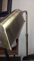 Close-up view of the lamp's gold tone metal shade showing a brushed finish.