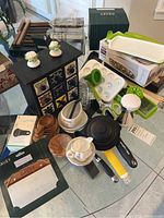 Lot overview with utensils, dough cutter, veggie chopper, flower decor, measuring scoops, pot with lid