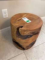 Full view of the solid wood trunk showing rounded top and carved irregularities on the side