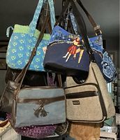 Photo of assorted pocket books hanging together showing variety of styles and materials