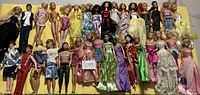 Full overview of all 32 dolls laid out showing variety of dolls and outfits.