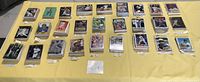 Top-down photo of a large collection of baseball cards sorted in stacks labeled with player names and series.