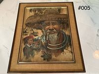 Full view of framed painting showing elderly man and young girl, mounted under glass with wooden and fabric frame.