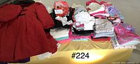 Red Rothschild coat and assorted folded girls clothes in size 3