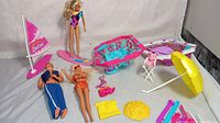 Clear image showing all toys and accessories in the vintage Barbie pool and beach set on white backdrop