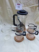 Full set including French press, four glass cups on cork coasters, and additional glass beaker.
