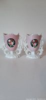 Photo of the pair of pink floral French porcelain bridal vases showing full front view