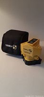 Photo showing laser square and black soft carrying case with Stabila branding.