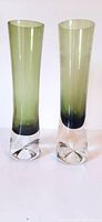 Front view of two tapered cylindrical glass vases with gradient coloring and clear bases