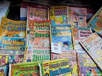 Photo of 16 vintage Richie Rich comic books with colorful intact jackets, featuring various titles and characters including Richie Rich, Jackie Jokers, and others.