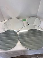 Photo showing all 4 round mirrors of varying sizes displayed on a surface with clean, clear reflection and no visible scratches.